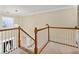 Stairway landing featuring white wood railing and stairs with neutral carpeting at 1811 Lake Cove Sw Dr, Atlanta, GA 30331