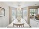 Bright dining area with modern chandelier, large windows, and view to a kitchen counter at 2770 Da Vinci Cres, Decatur, GA 30034