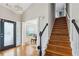 Inviting entryway with hardwood floors, staircase, chandelier and view into the piano room at 2770 Da Vinci Cres, Decatur, GA 30034