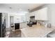 Well-lit kitchen with granite countertops, black appliances, and tiled floors in a modern home at 2770 Da Vinci Cres, Decatur, GA 30034