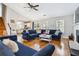 Bright living room features hardwood floors, a ceiling fan, and a stylish blue sectional sofa at 2770 Da Vinci Cres, Decatur, GA 30034