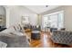Comfortable living room with hardwood floors, bay window, and stylish gray furnishings at 2770 Da Vinci Cres, Decatur, GA 30034