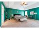 This spacious main bedroom features vibrant wall color, tray ceiling, and stylish decor at 2770 Da Vinci Cres, Decatur, GA 30034