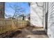 Side view of backyard patio with wooden fence and access to sliding glass door of home at 303 Brandywine Cir, Atlanta, GA 30350