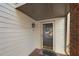 Welcoming front porch with brick accents, a storm door, and a stylish light fixture at 303 Brandywine Cir, Atlanta, GA 30350