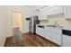 Well-lit kitchen featuring stainless steel appliances, white cabinets, and hardwood floors at 303 Brandywine Cir, Atlanta, GA 30350