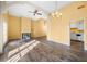 Sun-lit living room with high ceilings, hardwood floors, fireplace, and an adjacent view of the kitchen at 303 Brandywine Cir, Atlanta, GA 30350