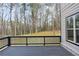 A backyard deck with dark brown railings and a beautiful view of the lush green yard at 346 Langford Dr, Norcross, GA 30071