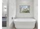 Bright bathroom features a soaking tub and a window with a view at 346 Langford Dr, Norcross, GA 30071
