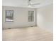 Bedroom featuring hardwood floors, two windows and a ceiling fan at 346 Langford Dr, Norcross, GA 30071