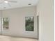 A well-lit bedroom with hardwood floors and two windows overlooking trees at 346 Langford Dr, Norcross, GA 30071