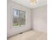 Bright, empty bedroom with hardwood floors, a large window, and recessed lighting at 346 Langford Dr, Norcross, GA 30071