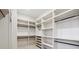 Custom walk-in closet with white shelving and black rods at 346 Langford Dr, Norcross, GA 30071