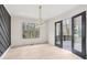 Dining room featuring a modern light fixture, a large window, and access to the outdoor patio at 346 Langford Dr, Norcross, GA 30071