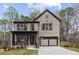 Charming home featuring a brick facade, a covered porch, and an attached garage at 346 Langford Dr, Norcross, GA 30071
