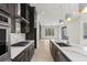 A modern kitchen with marble countertops, stainless steel appliances, and dark brown cabinets with hardwood floors at 346 Langford Dr, Norcross, GA 30071