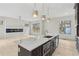 A kitchen island with marble countertops and stainless steel appliances with hardwood floors and a modern fireplace in the background at 346 Langford Dr, Norcross, GA 30071