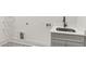 A laundry room featuring modern sink, stylish tile flooring, and shelving at 346 Langford Dr, Norcross, GA 30071