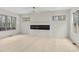 A modern living room with a long electric fireplace, hardwood floors and bright white walls and trim at 346 Langford Dr, Norcross, GA 30071