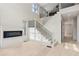 Open living room featuring a modern fireplace, hardwood floors, and a staircase with black railings at 346 Langford Dr, Norcross, GA 30071