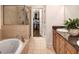 Bathroom with soaking tub, shower, granite countertop, and large walk in closet at 45 Honour Nw Ave, Atlanta, GA 30305