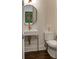 Chic powder room with a sleek floating sink, gold fixtures, an octagonal mirror and a modern toilet at 45 Honour Nw Ave, Atlanta, GA 30305