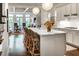 Bright, open kitchen with white cabinets, marble countertops, and a large island with seating at 45 Honour Nw Ave, Atlanta, GA 30305