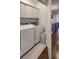Efficient laundry room featuring modern appliances and storage cabinets at 45 Honour Nw Ave, Atlanta, GA 30305