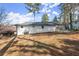 Image of the backyard shows the white-painted brick exterior, fencing, and trees at 1937 Joseph Ct, Decatur, GA 30032