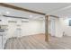 Finished basement area with wood-look flooring, exposed wood beams, and white cabinetry at 1937 Joseph Ct, Decatur, GA 30032