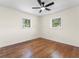 Bright bedroom featuring hardwood floors, two windows, and a modern ceiling fan at 1937 Joseph Ct, Decatur, GA 30032