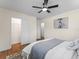 Bedroom features a ceiling fan, hardwood floors, closet access, and a large window at 1937 Joseph Ct, Decatur, GA 30032