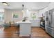 Bright, open kitchen with an island, white cabinets, stainless steel appliances, and hardwood flooring at 1937 Joseph Ct, Decatur, GA 30032