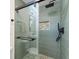 Modern shower with gray tiled walls, a pebble-lined niche, and a frameless glass door at 1937 Joseph Ct, Decatur, GA 30032