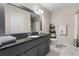 Bathroom featuring vanity with granite countertop, framed mirror and white tiled floor at 3346 Stonecrest Ct, Atlanta, GA 30341