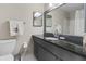 Bathroom featuring vanity with granite countertop, framed mirror and white tiled floor at 3346 Stonecrest Ct, Atlanta, GA 30341