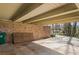 Carport featuring a brick wall, wooden beams, and ample space for parking in a well-maintained area at 3346 Stonecrest Ct, Atlanta, GA 30341