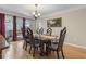 Elegant dining room with a wooden table, stylish chairs, and large windows at 3346 Stonecrest Ct, Atlanta, GA 30341
