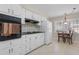 Efficient kitchen featuring white cabinetry, black countertops, and a cozy breakfast nook at 3346 Stonecrest Ct, Atlanta, GA 30341