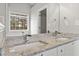 Bathroom with a double sink granite vanity and a large mirror reflecting natural light at 2279 Perch Sw Way, Marietta, GA 30008