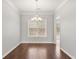 Formal dining room with wood floors, a chandelier, and a large window, ideal for Gathering meals at 2279 Perch Sw Way, Marietta, GA 30008