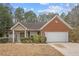 Charming one-story home featuring a combination of brick and siding, lush landscaping, and an attached two-car garage at 2279 Perch Sw Way, Marietta, GA 30008