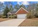 Inviting one-story home showcasing brick and siding exterior, manicured shrubs, and an attached two-car garage at 2279 Perch Sw Way, Marietta, GA 30008
