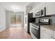 Modern kitchen area with stainless steel appliances, granite counters, and sliding glass doors to the backyard at 2279 Perch Sw Way, Marietta, GA 30008