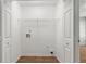 Laundry room with washer hookup and storage shelves, and laminate flooring at 2279 Perch Sw Way, Marietta, GA 30008