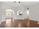 Open-concept living area with wood floors, arched entryways, and a view into the dining and kitchen spaces at 2279 Perch Sw Way, Marietta, GA 30008