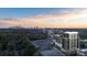 Breathtaking aerial view of a modern high-rise against a vibrant city skyline at sunset, showcasing urban living at 2425 Peachtree Ne Rd # 1705, Atlanta, GA 30305