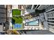 Aerial view of rooftop amenities including a pool, pickleball court, lounge chairs, and manicured green spaces at 2425 Peachtree Ne Rd # 1705, Atlanta, GA 30305