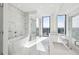 Luxurious bathroom with a standalone tub, glass-enclosed shower, and double vanity sinks at 2425 Peachtree Ne Rd # 1705, Atlanta, GA 30305