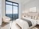 Serene bedroom with a plush bed, soft lighting, and floor to ceiling windows overlooking lush surroundings at 2425 Peachtree Ne Rd # 1705, Atlanta, GA 30305
